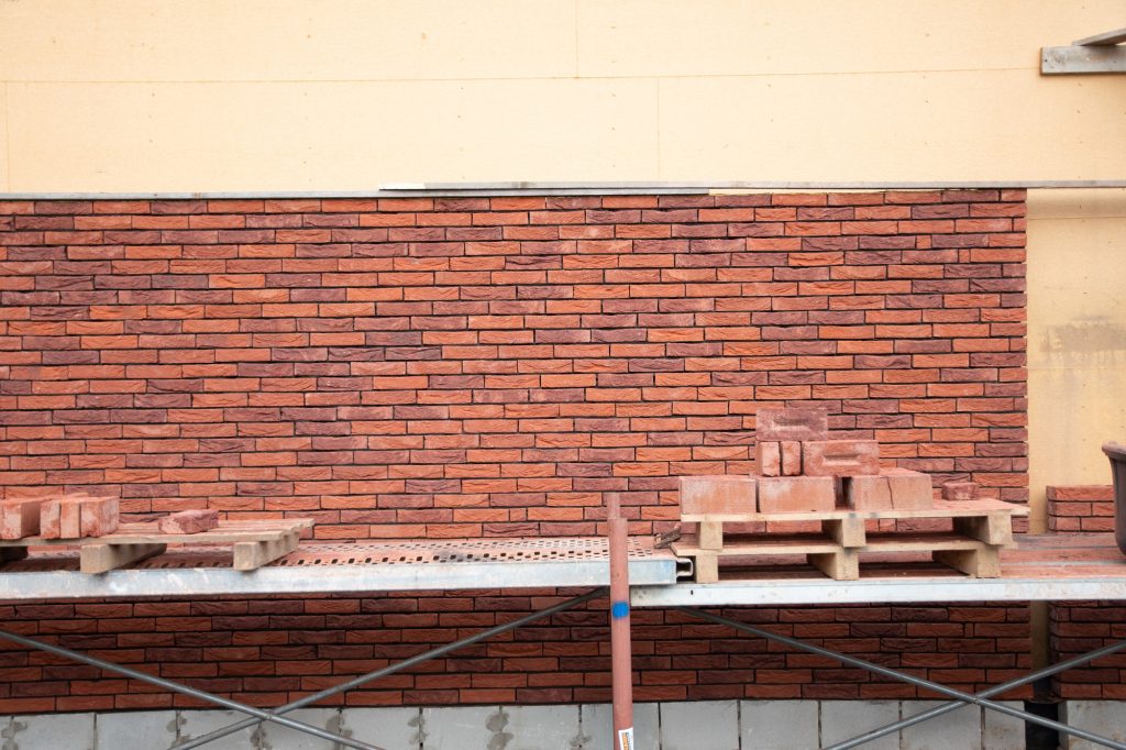 a new house is being built, walls and the beginning of brickwork, various building materials