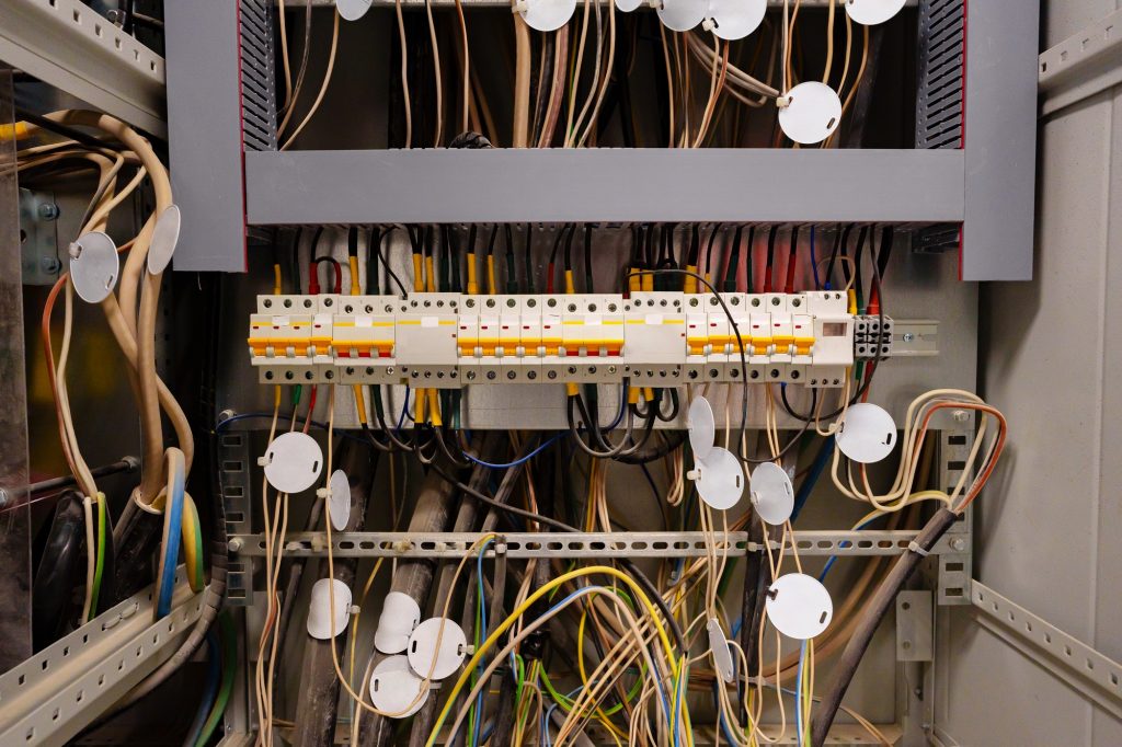 Close view of complex electrical wiring in a control panel at a technology facility