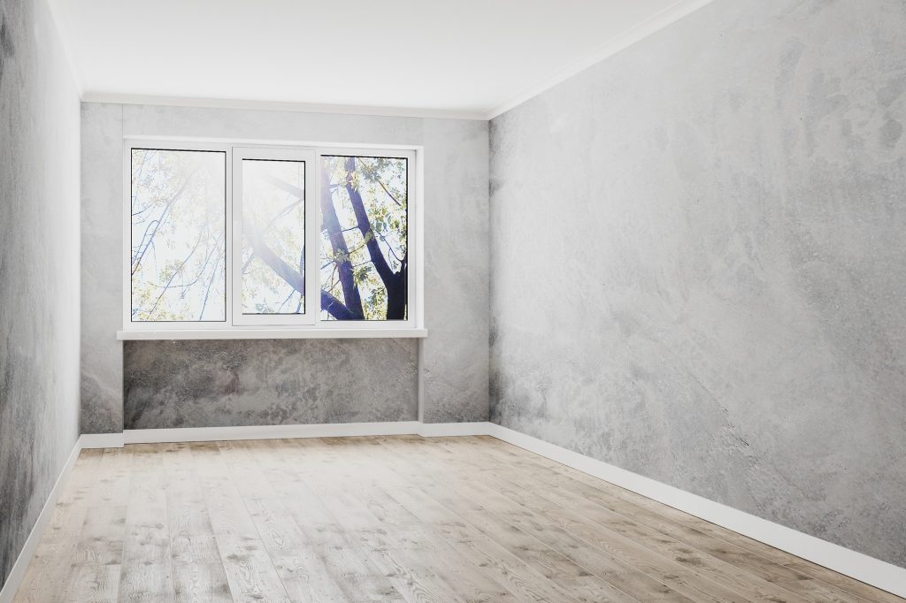 empty room with window, empty decorative plaster walls and wooden floor