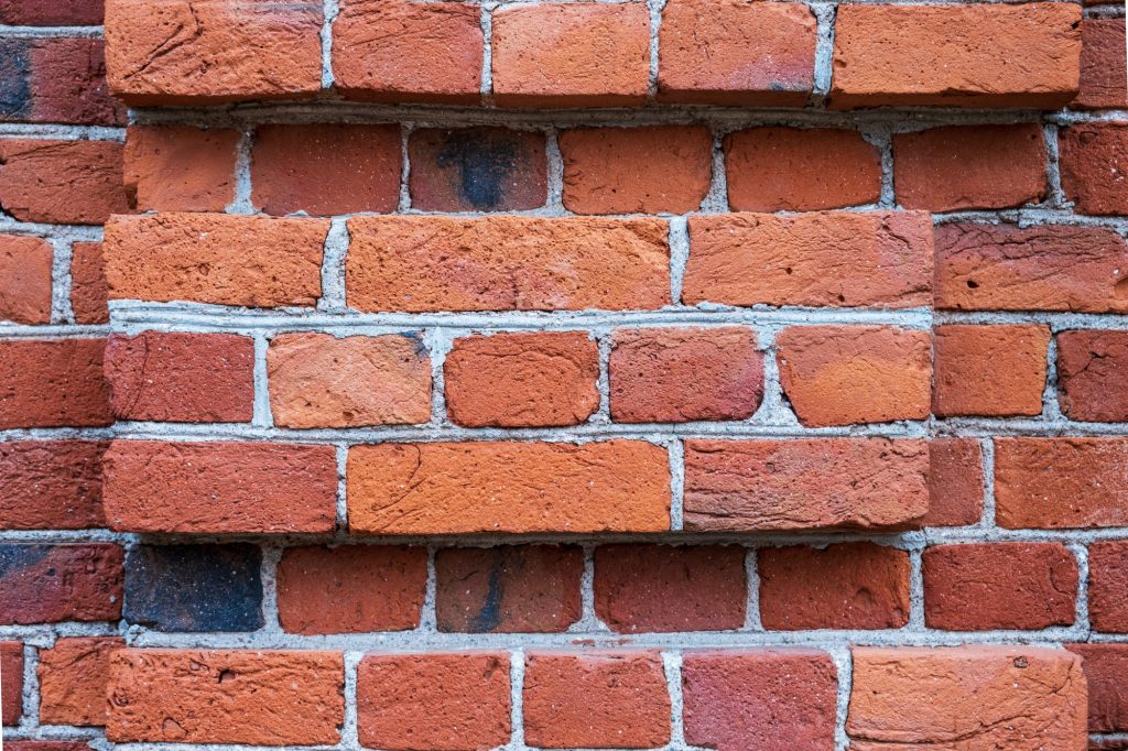 Fragment of a wall of a red brick building.